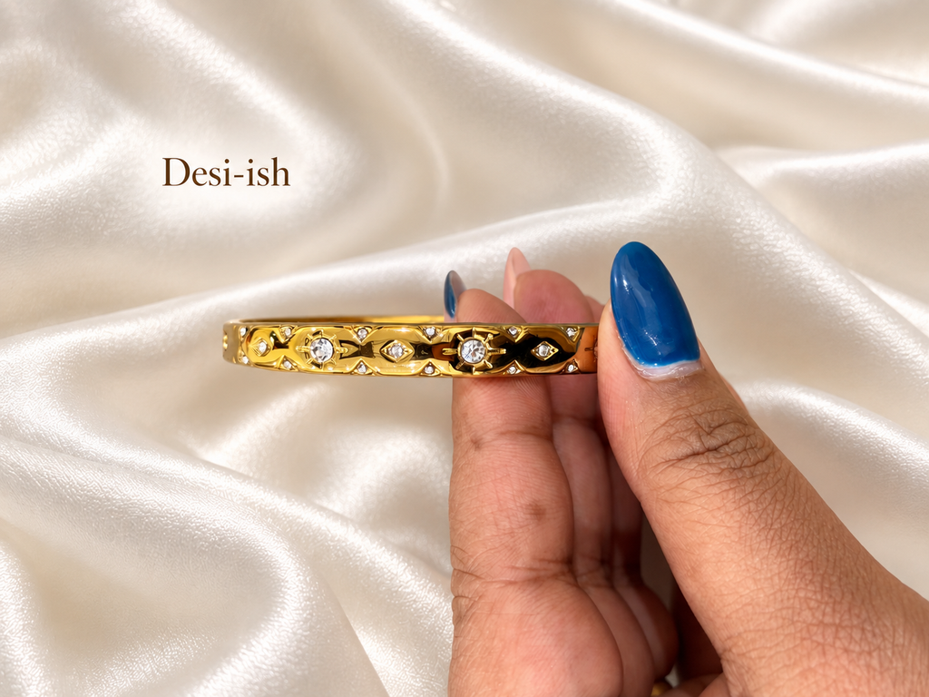 Crystal Gaze Kada held close up against white satin
